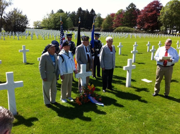 Veterans of the 106th ID along with a German veteran of the battle gather at Wood's grave for a ceremony in 2012. John Gatens is second from left.