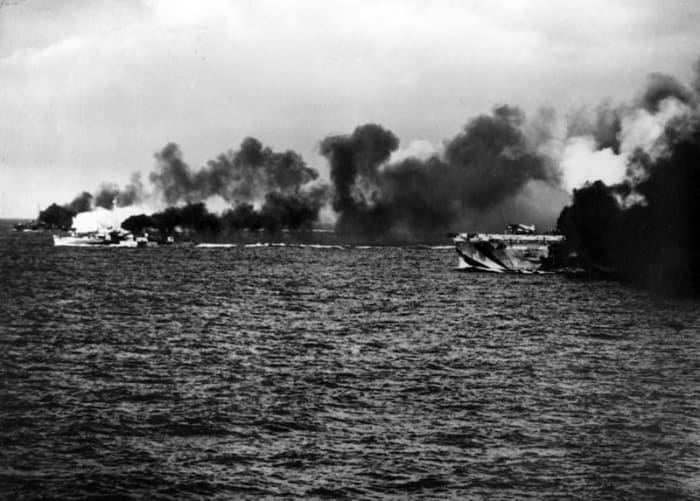World War II: Escort carrier Gambier Bay and her escorts laying a smoke screen early in the battle.