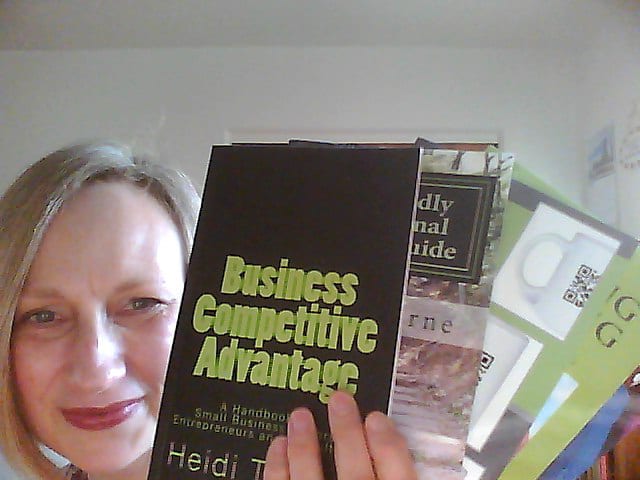 Self published author, Heidi Thorne, shows several perfect bound books she has published.
