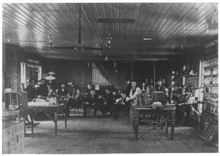 1880 photograph shows of the Menlo Park lab. Surrounding Edison are laboratory assistants, who carried out the many details of Edison’s experiments.
