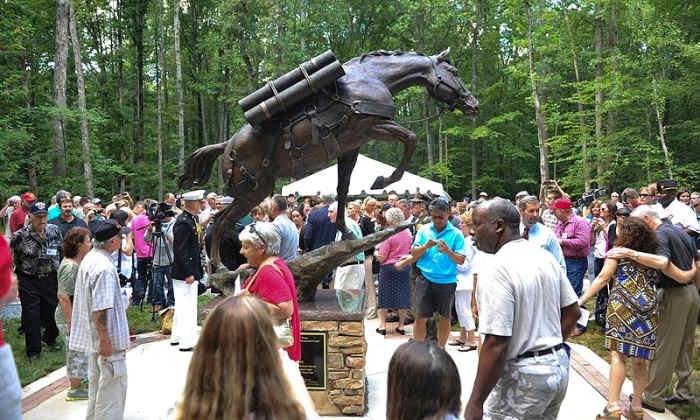 Visitors view the full-size bronze statue of Korean War Horse Staff Sgt. Reckless at the National Museum of the Marine Corps, Triangle, Va., July 26, 2013. The Commandant of the Marine Corps, Gen. James F. Amos, was in attendance.