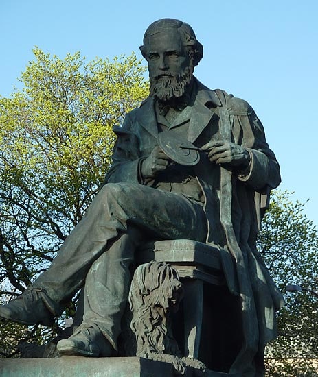 Statue of James Clerk Maxwell on George Street in Edinburgh, Scotland. Maxwell is holding his color wheel and his dog “Toby” is at his feet.