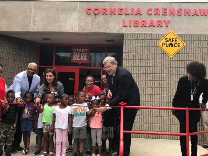 Mayor Jim Strickland (white shirt, dark suit) cuts the ribbon at the opening of the reimagined Cornelia Crenshaw Library branch in September 2019 in Memphis.