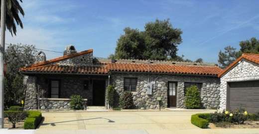 This historic California home has a few old orange trees lined in rows. The detached garage very much looks like it was done later, but it is a very good match. No one could be unhappy with it.