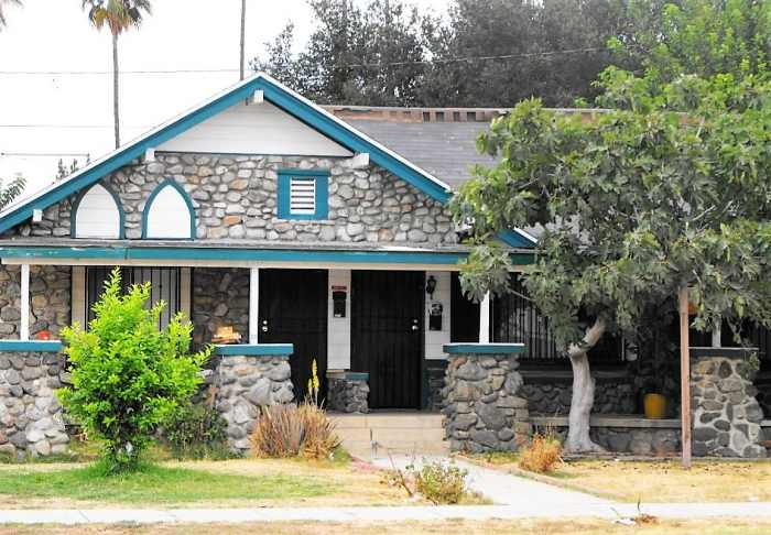 A bungalow duplex with field stone construction. You can imagine by the work of the cement that needed repairs were done, or different masons worked on the pillars. This house is located in Pomona, CA.
