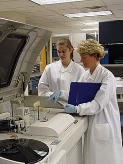 A typical analyzer in the chemistry department. Here you can see a new tech or maybe a student receiving some training. Every time the lab gets a new analyzer, we must go through training to learn how to use it.