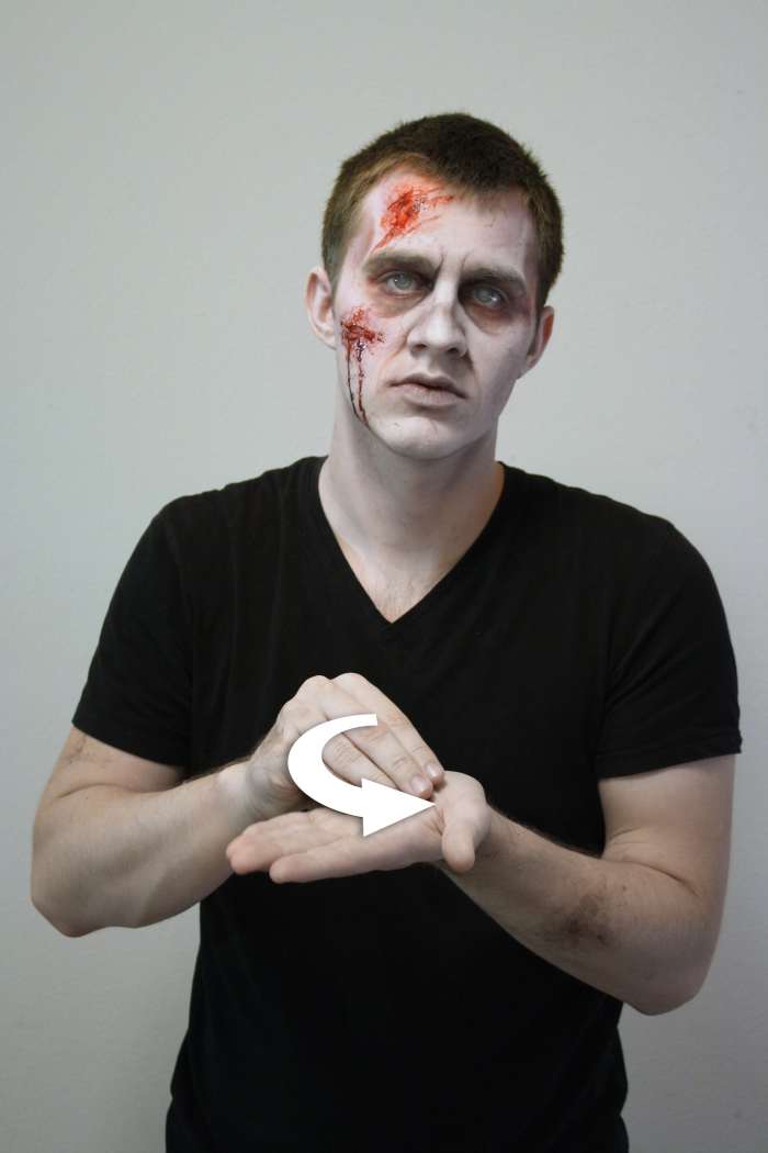 The non-dominant hand is held out palm open, then the dominant hand makes a circular motion with a flattened 'O' hand.
