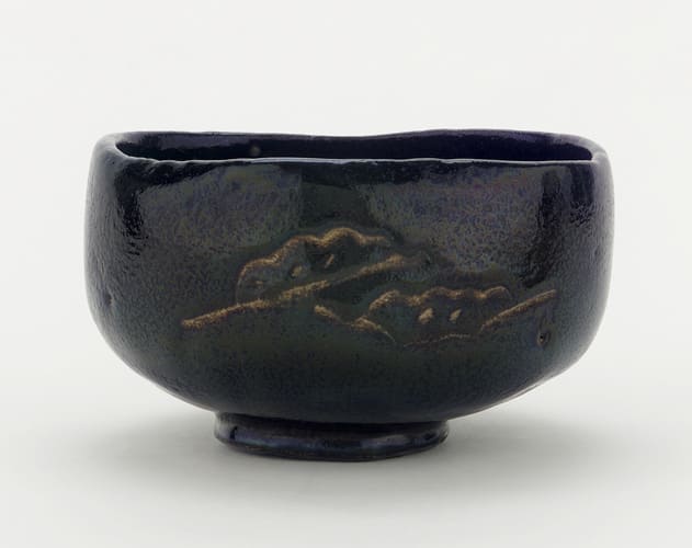 A 17th or 18th century-era chawan with pine boughs and interlocking circles on display at the Freer Gallery of Art in the Smithsonian Institution, Washington, DC, USA. This piece was made in an unknown raku kiln in Kyoto.