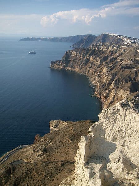 These 1000 foot tall cliffs curve around, forming the inner walls of a ring of islands comprising modern-day Santorini (Thera). They are what's left of the magma chamber of the ancient volcano that exploded, the cracked rim of a fiery cauldron!