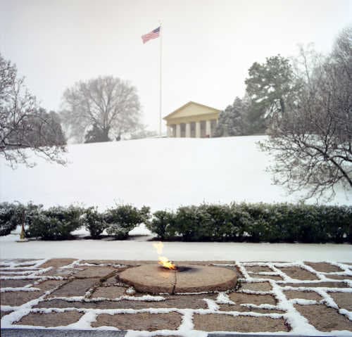 President Kennedy Gravesite and Eternal Flame with Robert E. Lee Mansion in Background