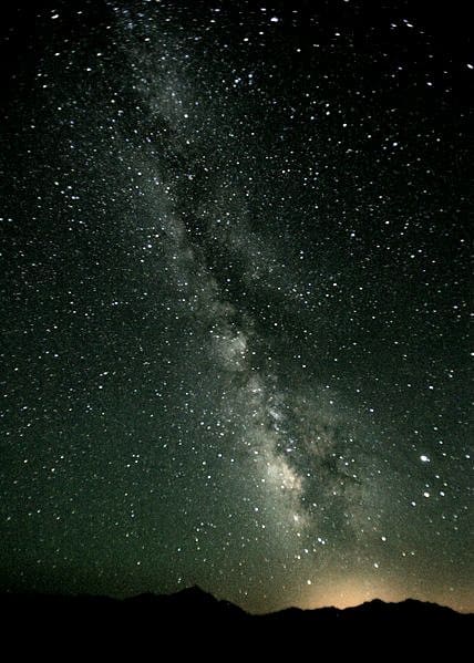 The Milky Way often shows a dark band dividing the hazy light band - a dark nebulous cloud similar to that found in some other galaxies and shown in the image of NGC 4565 in the previous section