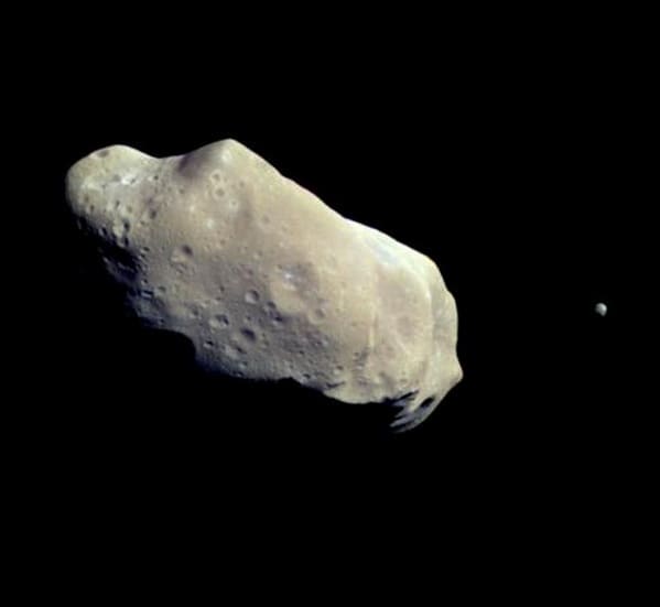 Ida is the large asteroid — 36 x 14 miles — with little egg-shaped Dactyl (dot at right) 1 mile long.