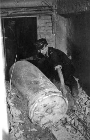WWII: Warsaw Uprising: Polish Home Army soldier measuring length of 600 mm dud ammunition from a "Karl" mortar.