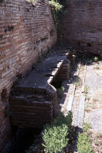 An Ancient Roman Latrine. Running water flushed the waste away but there was no paper. Sponges on sticks and soaked in salty water were used instead.