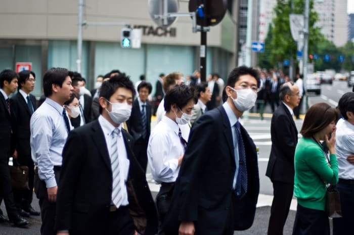 People wearing masks. Fear of SARS or Swine flue causes many people to wear face masks.