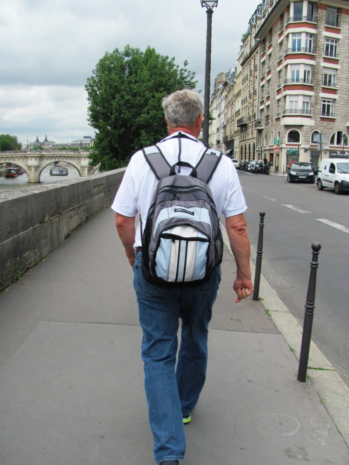 My dad walks alongside the River Seine in Paris near the location of the French National Police on the Ile de la Cite.