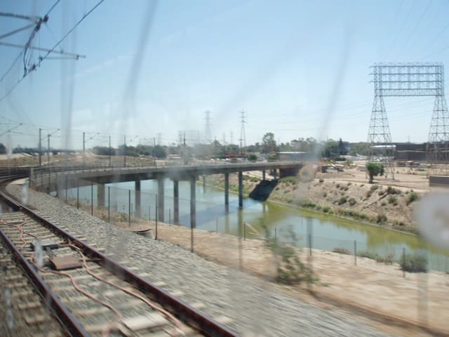 Los Angeles River as seen through the window of a subway train. Note the difference from its original, natural state pictured above.