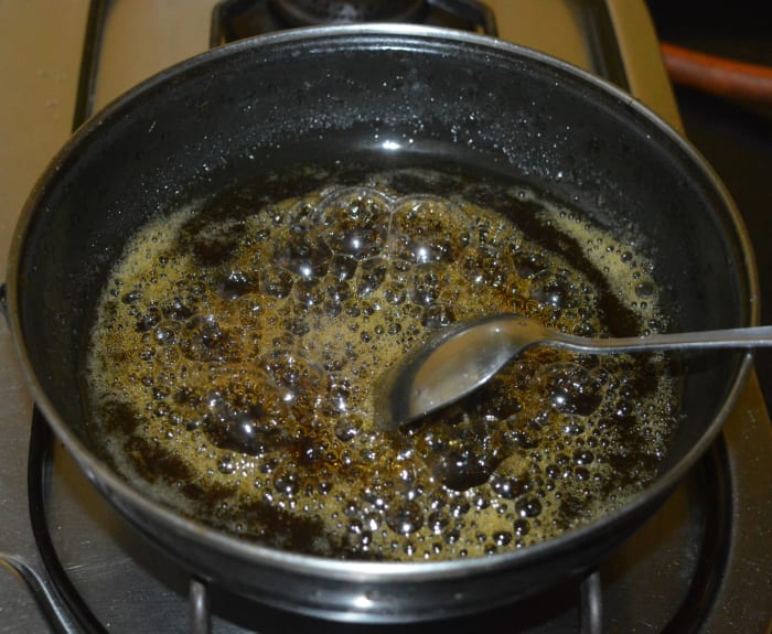 When the mixture becomes a little bit thick, turn off the heat and transfer the hot liquid jaggery to the bowl while sieving it to remove any impurities.