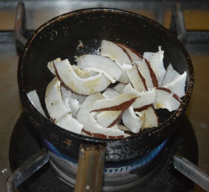 Saute the copra in some ghee until they get light golden brown spots here and there. Add it to the plate containing roasted almonds and cashew nuts. Allow them to cool down.