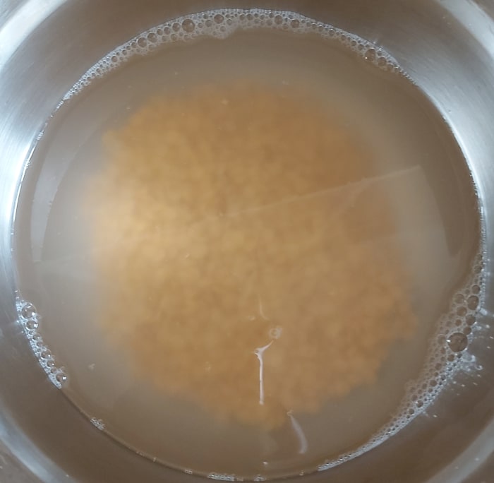 Rinse them well 2-3 times. Add water and soak it for 10-15 minutes (or more). Soaking will expedite the cooking process of lentils. You can skip the soaking step, if you prefer.