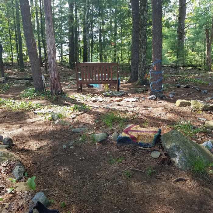 The arrow rock I painted at the entrance of the labyrinth I walk daily when the weather in New England permits.