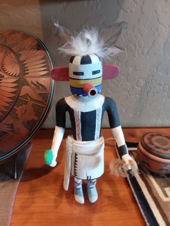 Notice that this Kachina does not have a base, which means that there isn't an artist's signature at the bottom. Really old Kachinas did not have a base, but the feathers appear new. Unsure of origin.