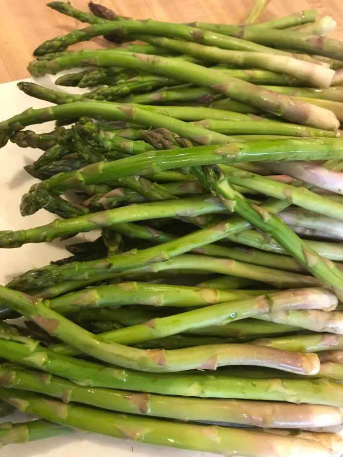 I like smaller, more tender asparagus. Look for pencil sized spears, and simply rinse them off before snapping off the ends.