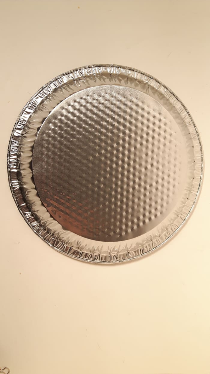 An upside down pie plate. The sides of the pie plate could alter how the cookies bake so turn it upside down.