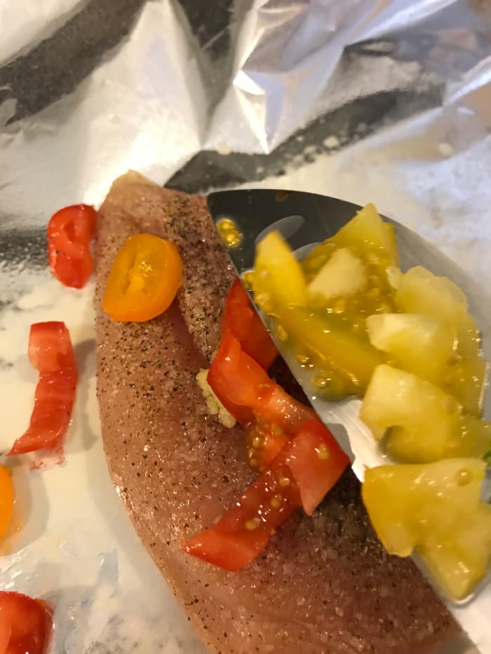 Use your favorite fresh vegetables for even more flavor. I used diced cherry tomatoes here. Cut small, they release their liquids into the packet, adding to the sauce that develops as the chicken cooks.