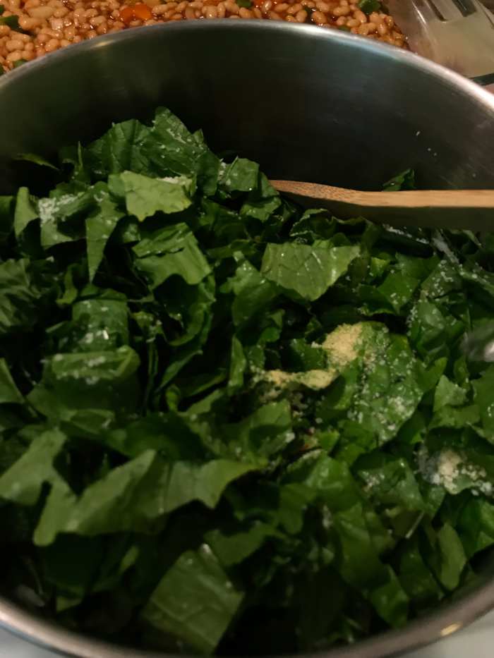 Add the red wine vinegar and water. Bring to a boil and reduce to a simmer. The vinegar helps mitigate any bitterness in the greens, and really makes a nice contrast.