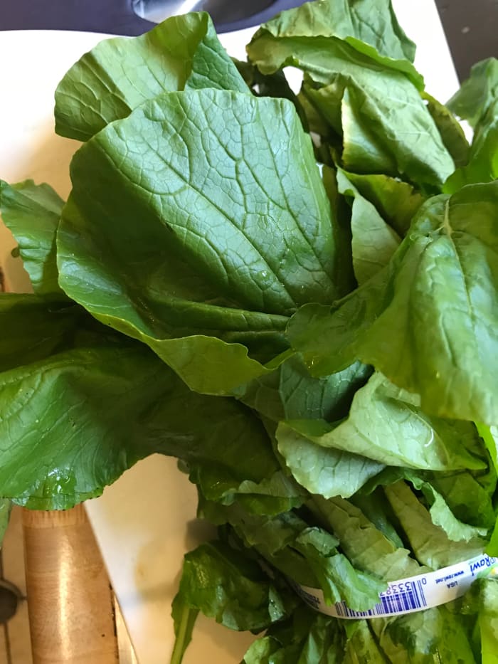 Wash the greens carefully—dark leafy greens tend to keep hold of sand and dirt, so even 'pre-washed' greens can use a good rinse. Separate the bunch and run the large leaves under cold water. Shake off the excess water, but don't worry about drying.