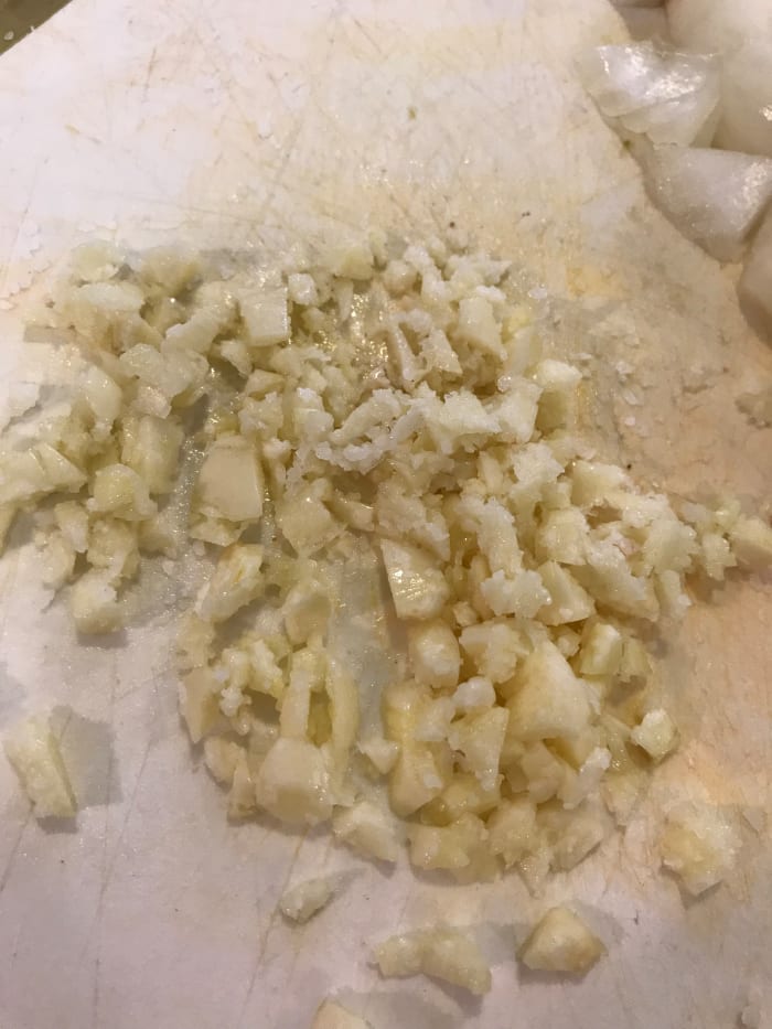 Because the garlic will cook for a long period of time, it will become sweeter and nuttier. I like to mince it, and add it after the veggies to help prevent the risk of burning it. Mince it with a little salt and olive oil to make mincing easier.