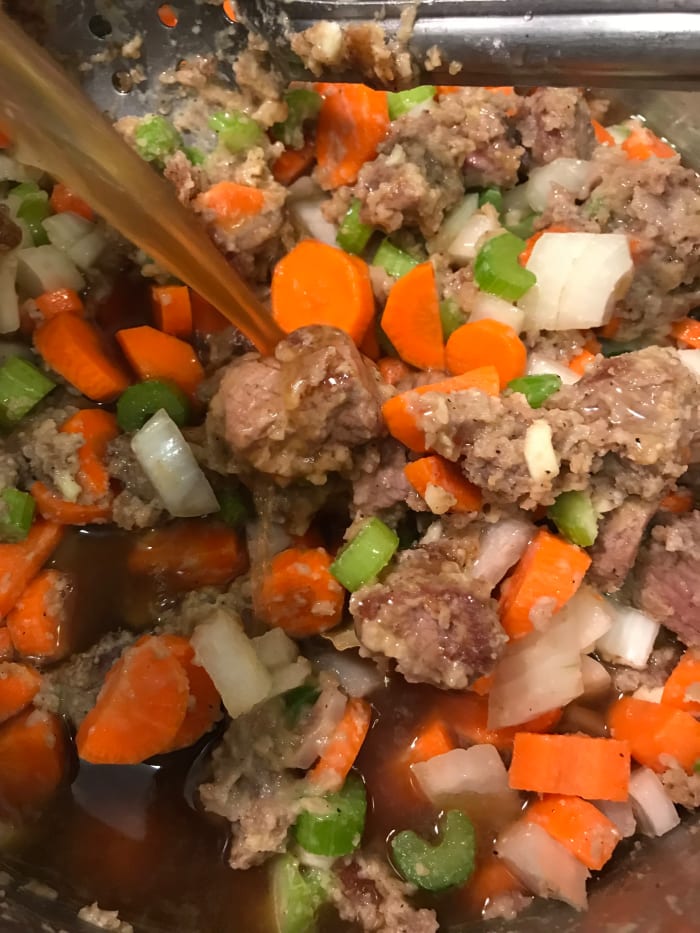 You can transfer the beef stew to a slow cooker at this point if you like. Then add the wine and beef stock. You can use red or white wine - it's to boost flavor and add a hint of acid, but not a dominate flavor by itself, so it's whatever you have.