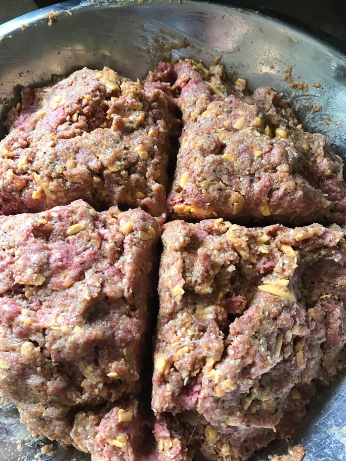 Mix together the meatloaf mixture, working gently. Try not to over mix the mixture, or it could make the end result tough. Divide the mixture into four equal portions and shape into loaves. If desired, some may be frozen up to a month.