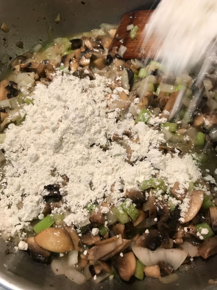 Stir in the flour until it's fully incorporated. This will provide the thickening power for the sauce, holding it together in the casserole as it bakes.