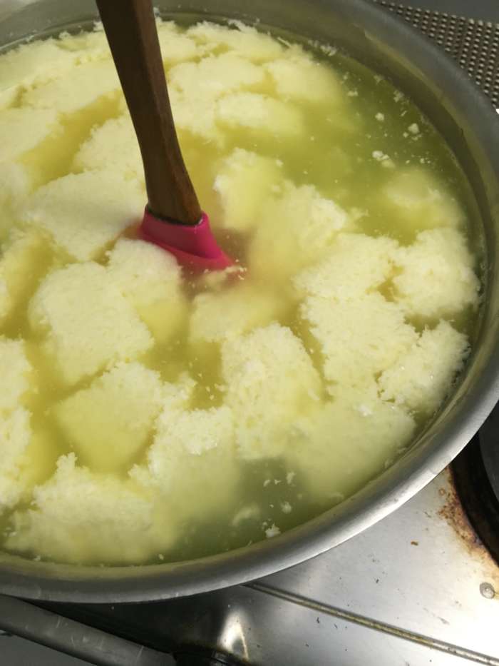 Stir and heat the curds gently until the whey reaches 105 degrees Fahrenheit (for pasteurized milk) or 90 degrees Fahrenheit (for raw milk).