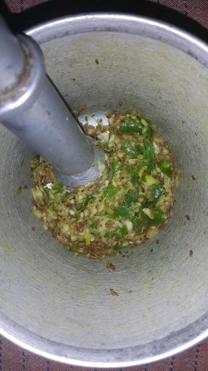 Green chillies, garlic, ginger, a little salt and cumin seeds (optional at the stage) grounded in a mortar and pestle.