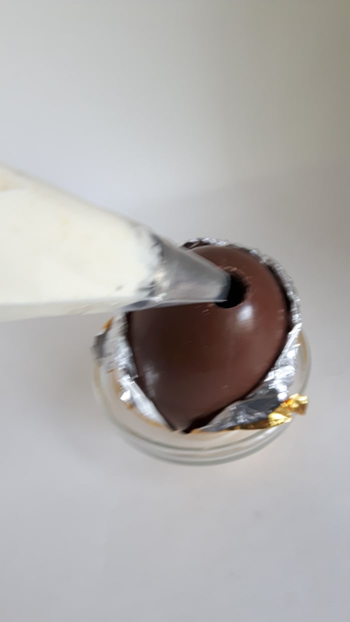 Step 9: Use a piping bag (or a plastic bag with the corner cut out) to put the pineapple mousse into the egg.