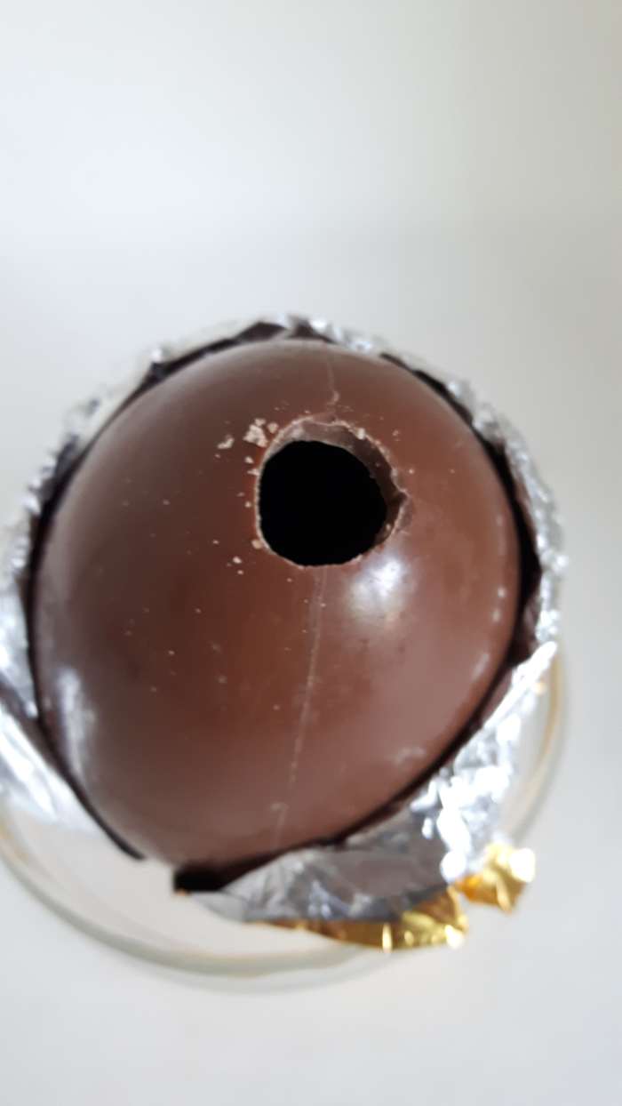 Step 8: Use a sharp pointed knife to drill a small hole in the top of the egg. Make the hole bigger by rotating the knife.