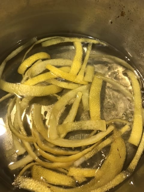 Bring the lemon peel, sugar and water to a boil, reduce to a simmer, and simmer for about 20 minutes. It'll depend a bit on how thick yours is cut, but you're looking for the lemon peel to turn translucent.