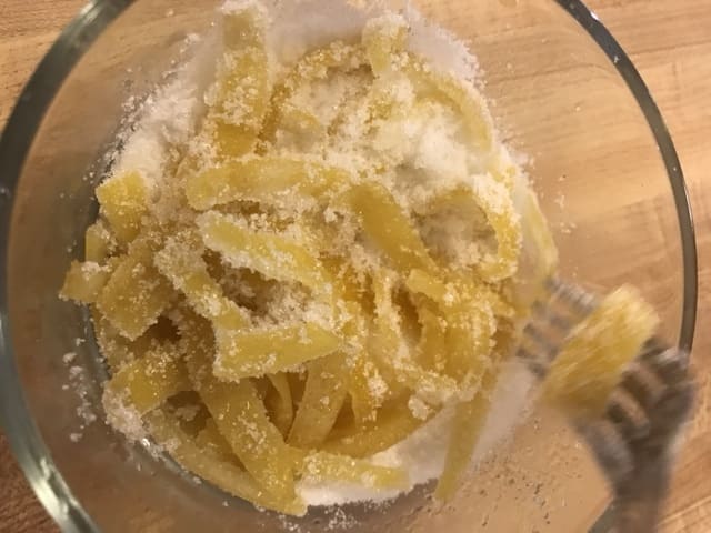 I've seen a lot recipes for candied lemon peel that tell you to mix the candied peels with the sugar by hand. I normally don't mind using my hands - but it gets everywhere! I find a fork does just as well.