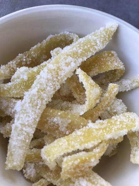 The candied lemon peel can be used as a garnish for cakes or cupcakes, or chopped and used as an ingredient in fruitcake. Fruitcake is actually delicious when made with real ingredients!
