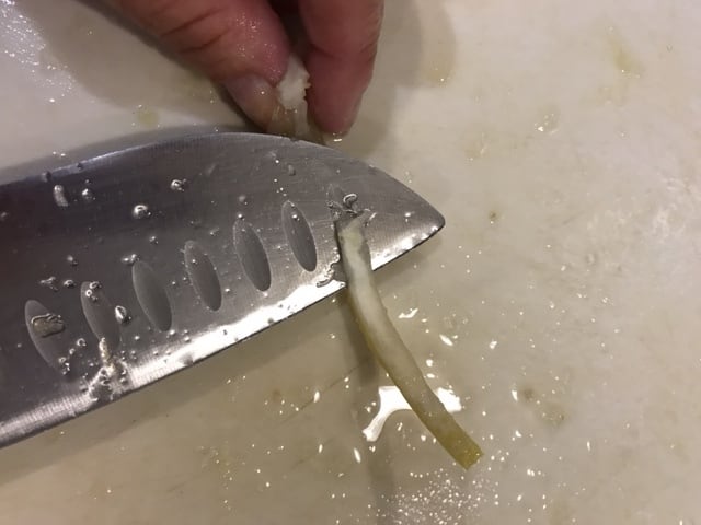 With the tip of knife, remove as much of the white pith as possible. This is extremely bitter, so this is an important step. Take your time and you'll have far better results.