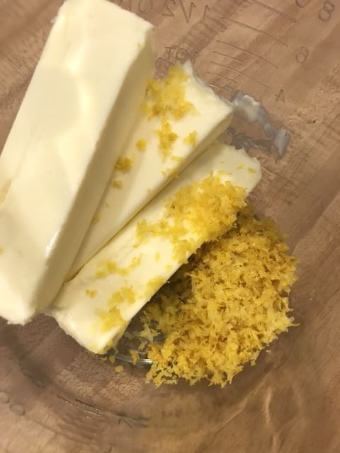 Loads of lemon zest beaten with butter until it's light and fluffy is the secret to the incredibly bright flavor of this homemade frosting recipe. The recipe calls for 3 tablespoons, which is roughly 3 lemons, but you can measure to be precise.
