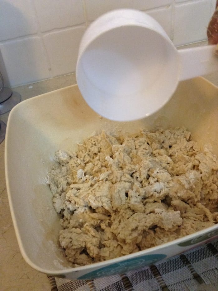 Make a dough by adding another cup. Knead well. Knead it using the knuckles of your hands.The purpose of kneading is to develop gluten in the dough.
