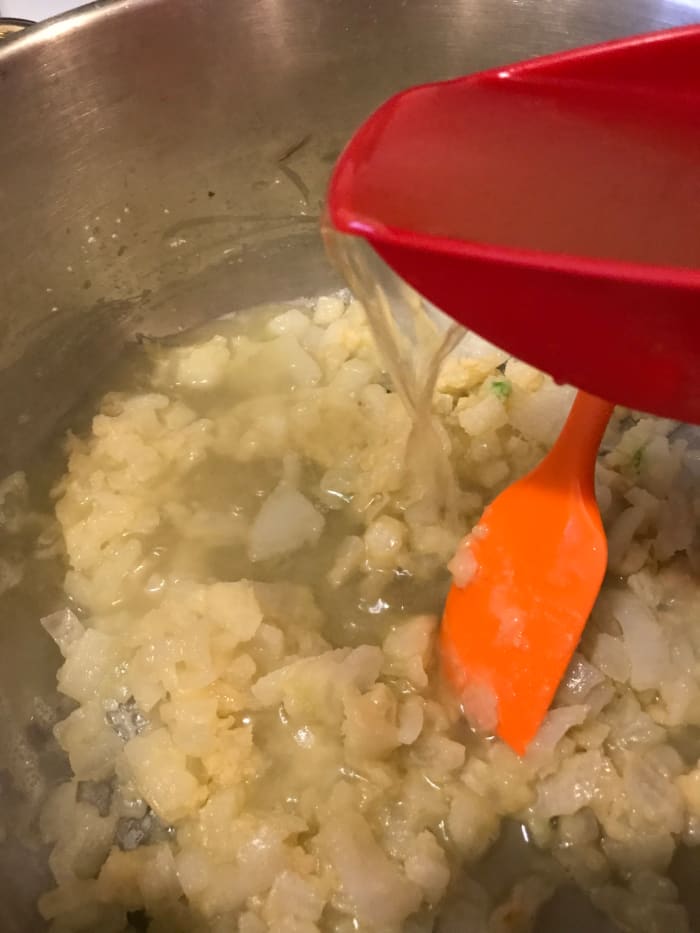 Whisk the flour into the butter and onion mixture, stirring constantly to incorporate the butter and flour fully. This will thicken the soup. Add the broth slowly in small batches, stirring between each, to avoid lumps.