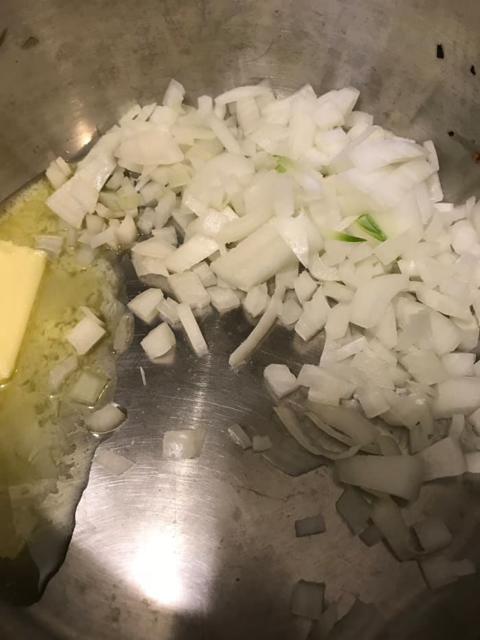 Melt butter over medium low heat. Add the onion and cook just a minute or so before adding the flour. This forms the flavor base for the soup.