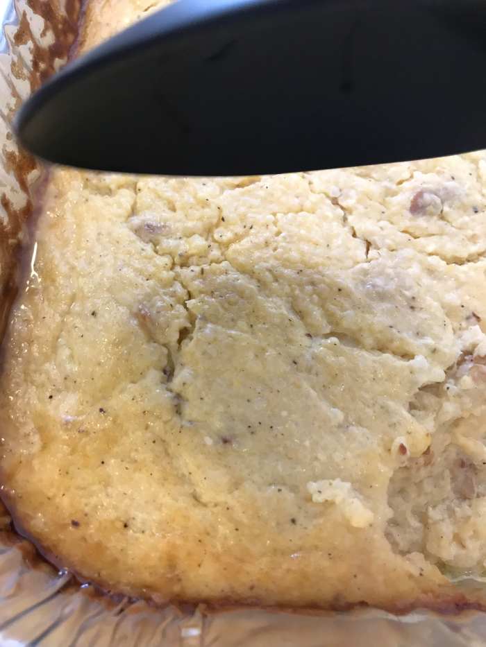 The bacon and cheese grits are done when the edges are set, the dish is bubbly throughout and the top is golden brown.