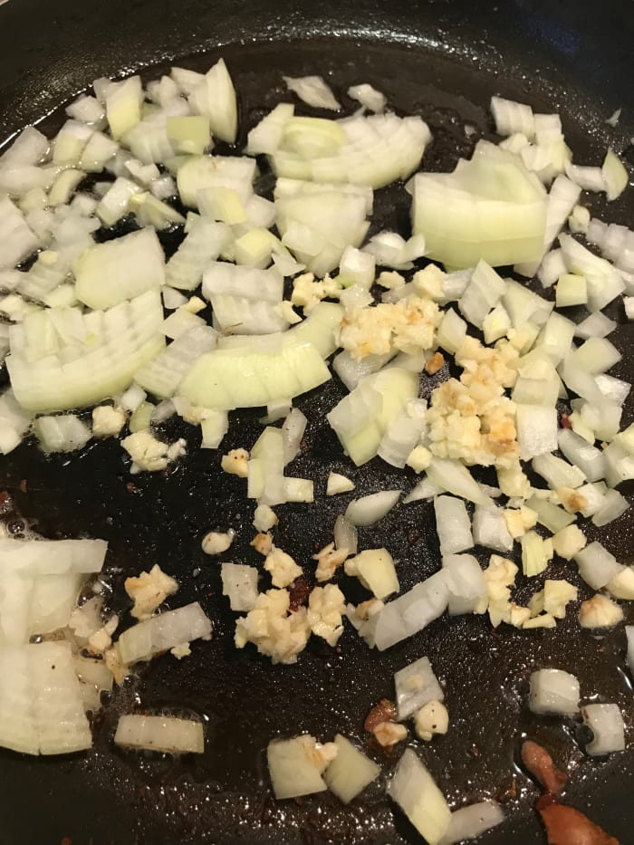 Keeping just a teaspoon of the bacon grease, saute the onions and garlic until fragrant and softened, about ten minutes.