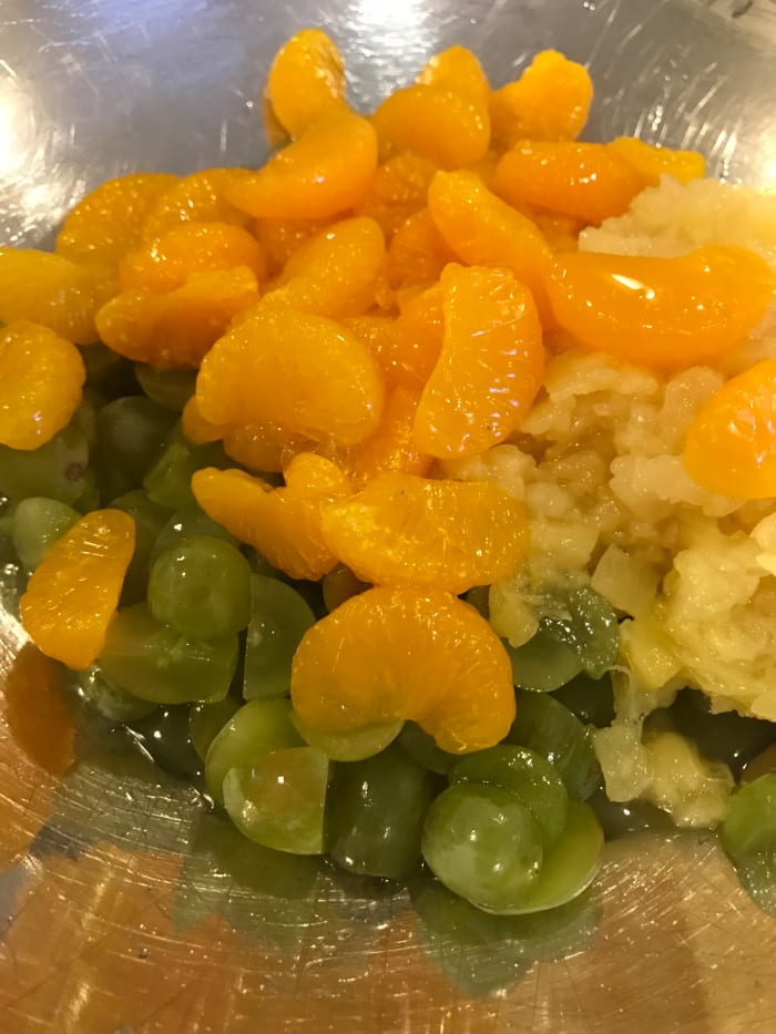 I like green grapes - I remember when my mother would buy them peeled and canned. I haven't seen those in years, so I just pick fresh grapes and cut them in half or quarters so they are roughly the same size.
